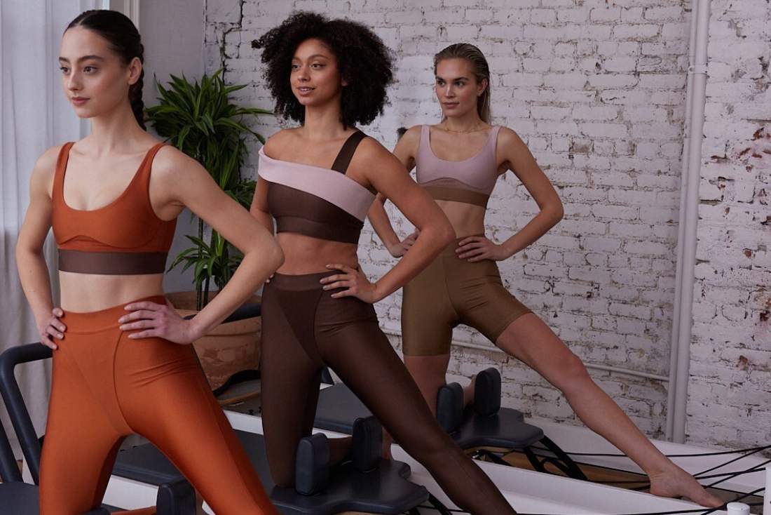 A group of people doing Pilates on the Reformer